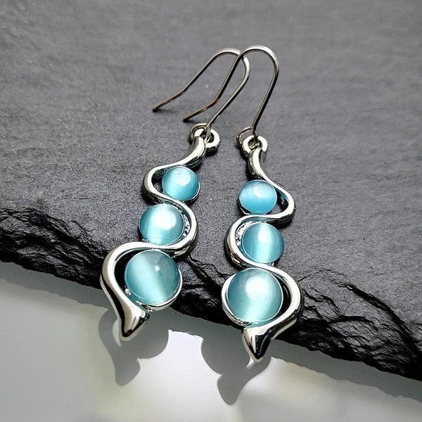 Boucles d’oreilles pendantes avec cristal bleu