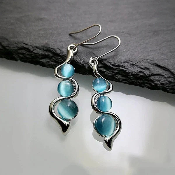 Boucles d’oreilles pendantes avec cristal bleu